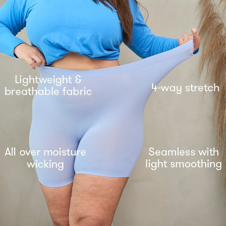 Front view of model wearing light blue seamless anti-chafe shorts showing 4-way stretch and moisture-wicking fabric on studio background