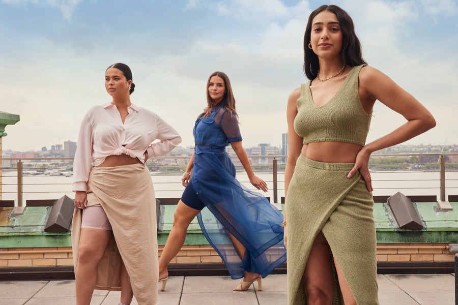 Three stylish women standing side by side