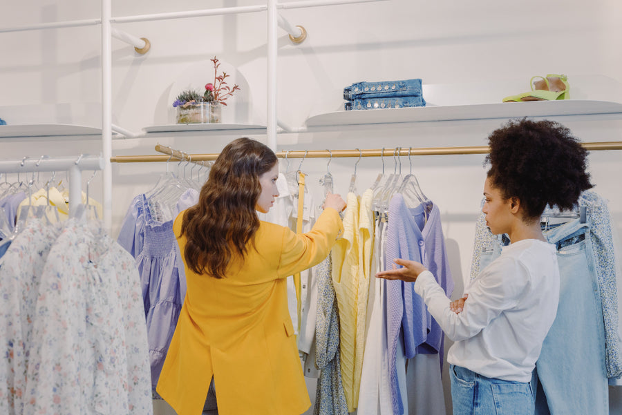 Two thin women shopping for clothes